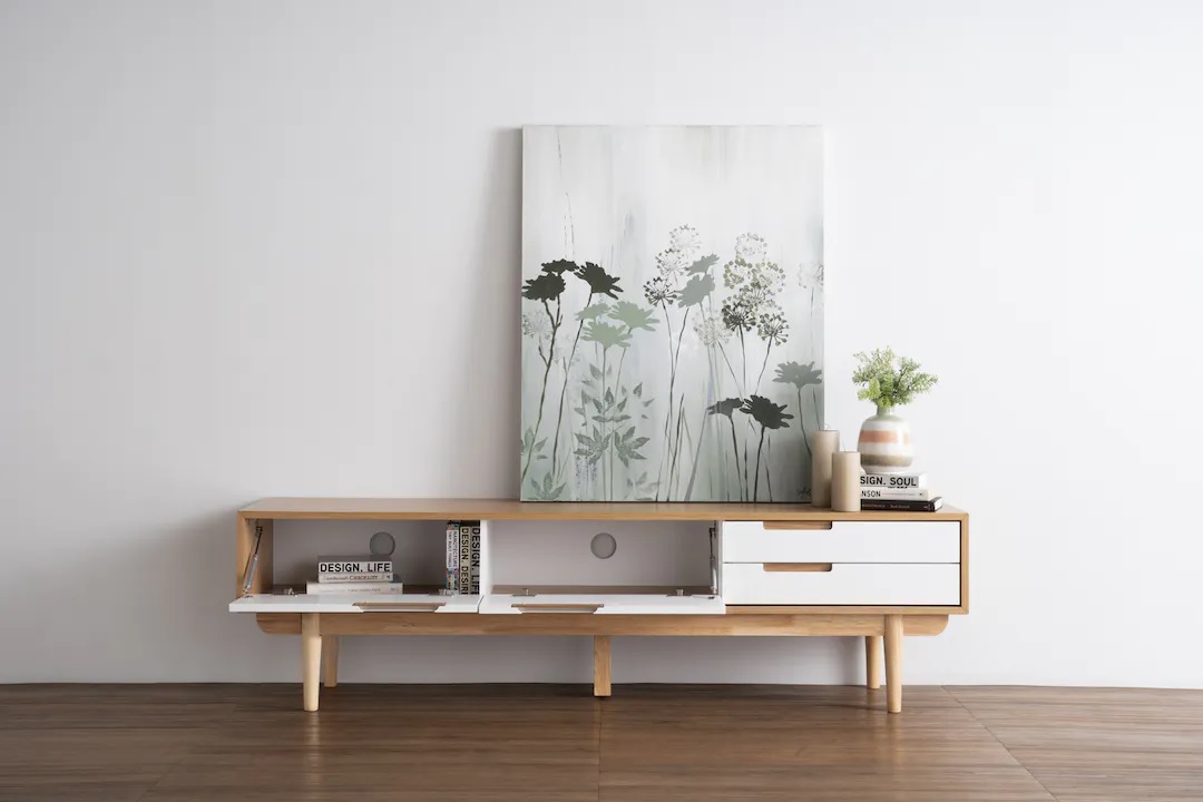 Brown and white TV cabinet made of solid oak, with 2 doors and drawers, and supported by wooden legs.