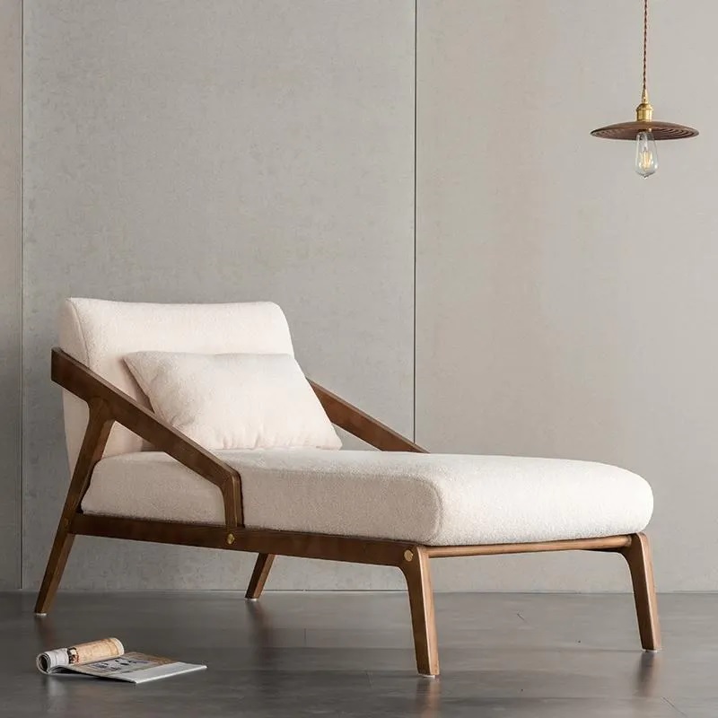 White chaise lounge upholstered in microfibre wool with wooden frame and legs.