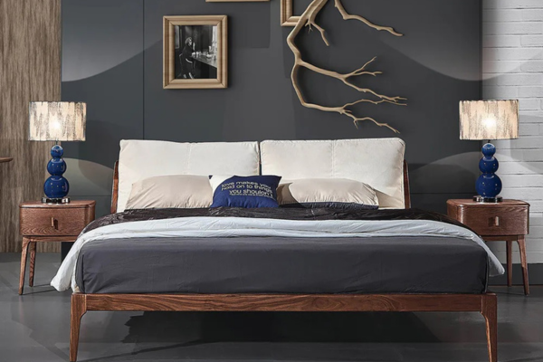 A brown queen-size platform bedframe made of solid ash wood, featuring a fabric cushioned headboard