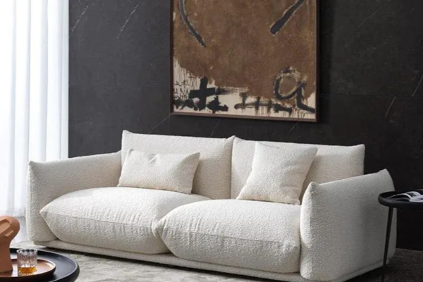 White 3-seater sofa with plushy seating, made in velvet, featuring curvy edges.