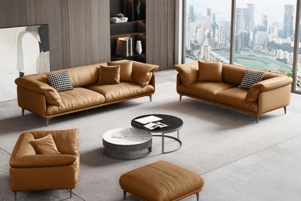European style 3-seater microfibre-leather sofa in brown with armrest cushions, pillows, and steel legs.