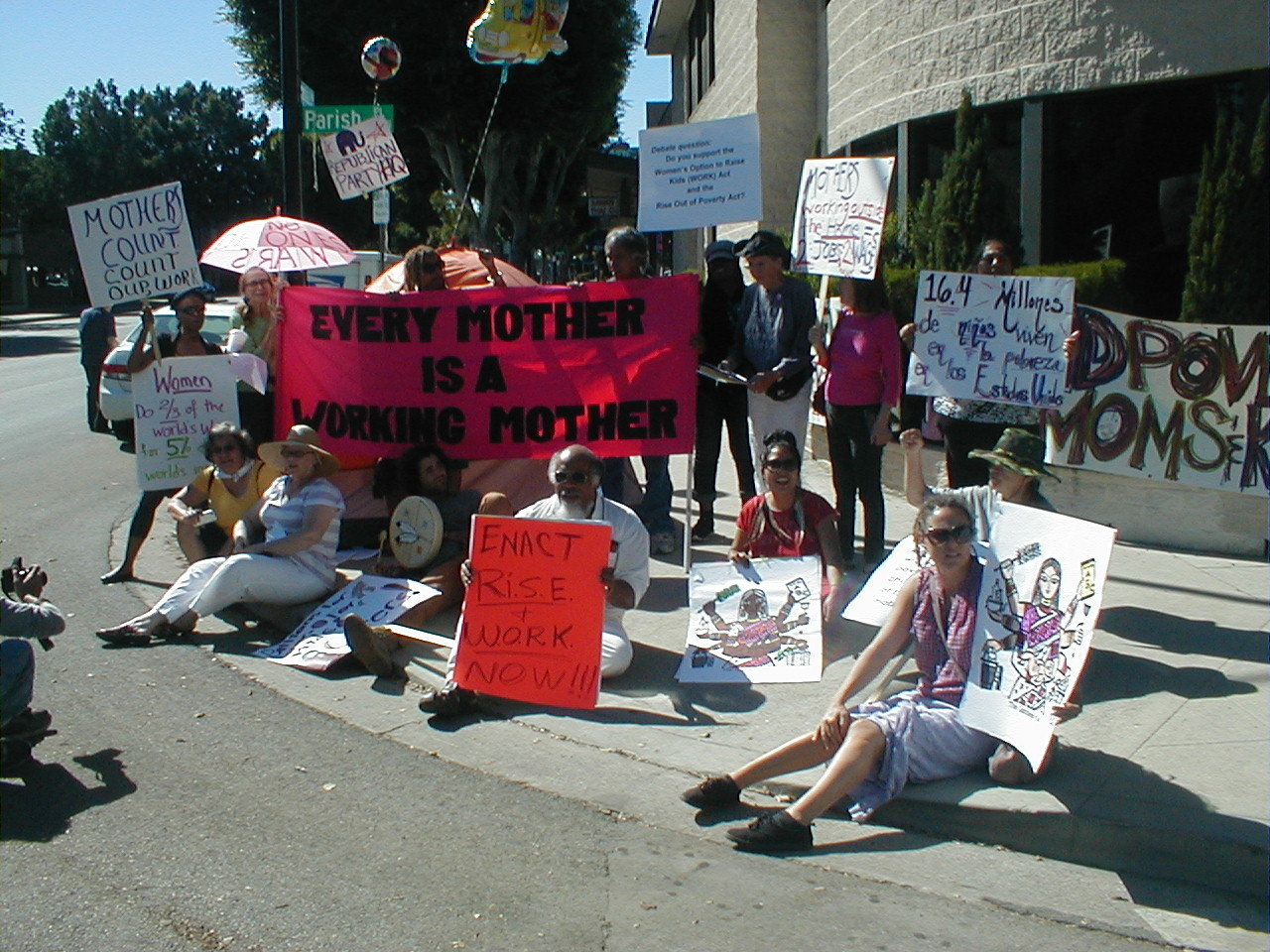A multiracial group of mothers, children, other caregivers, occupiers, women and men including older people and youth, held a Speakout and Protest outside the Republican Party Headquarters in Burbank, California on Monday October 15th the eve of the October 16th next presidential debate.