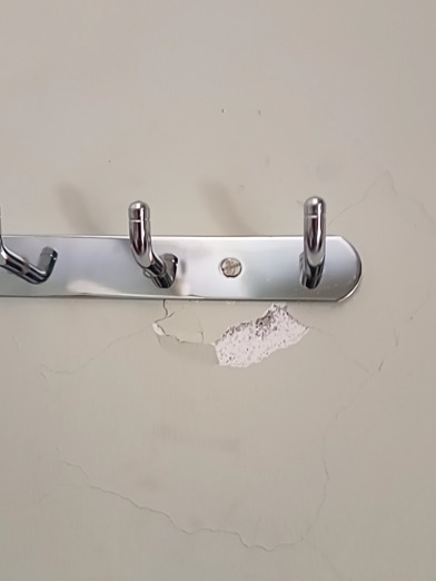 Fixing a Cracked Wall Plaster After Hinge Installation