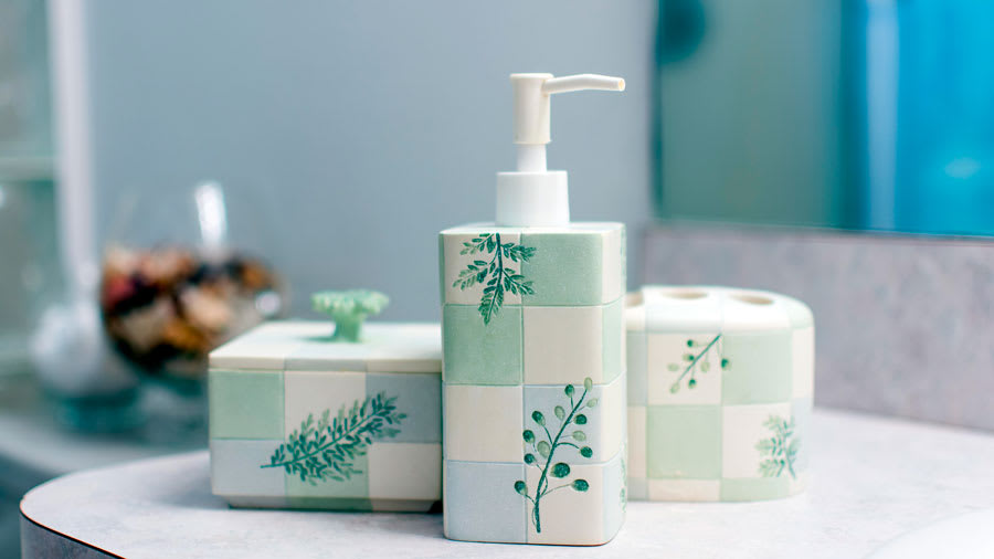 Pastel blue and green and white bathroom set on sink countertop