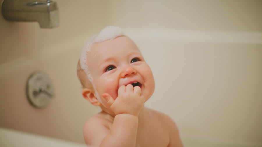 soap suds from bath on baby head