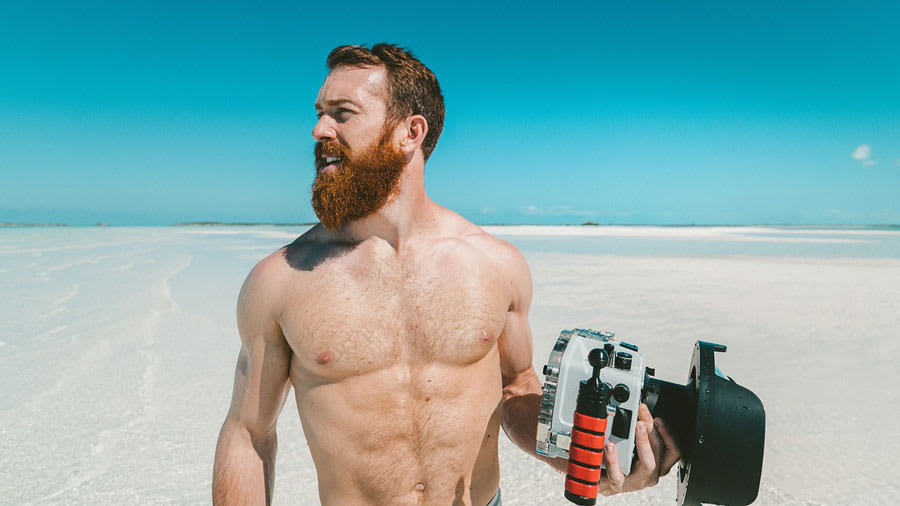 Shirtless man on the beach with sparse body hair