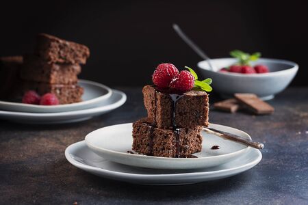 Chocolate cake with caramel, raspberry and mint, selective focus image Stock Photo