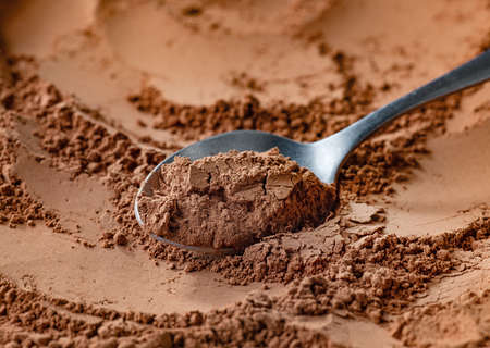 Spoon of fine cocoa powder Stock Photo