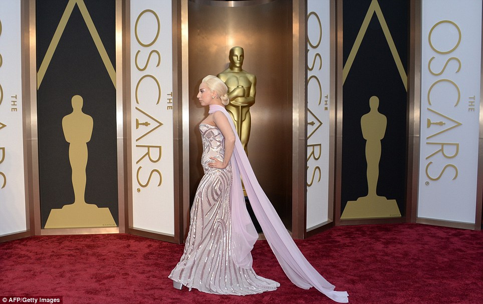 Embroidered elegance: Gaga teamed her striking gown with a chic updo and flowing scarf