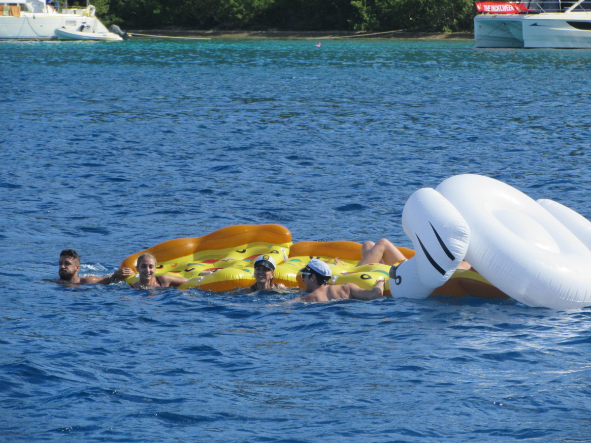 Lots of people having fun on inflatable pizza