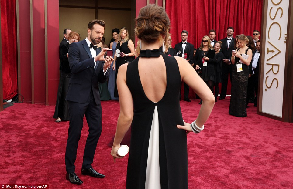 Snap happy: Jason Sudeikis took a picture of his fiance Olivia Wilde on the carpet