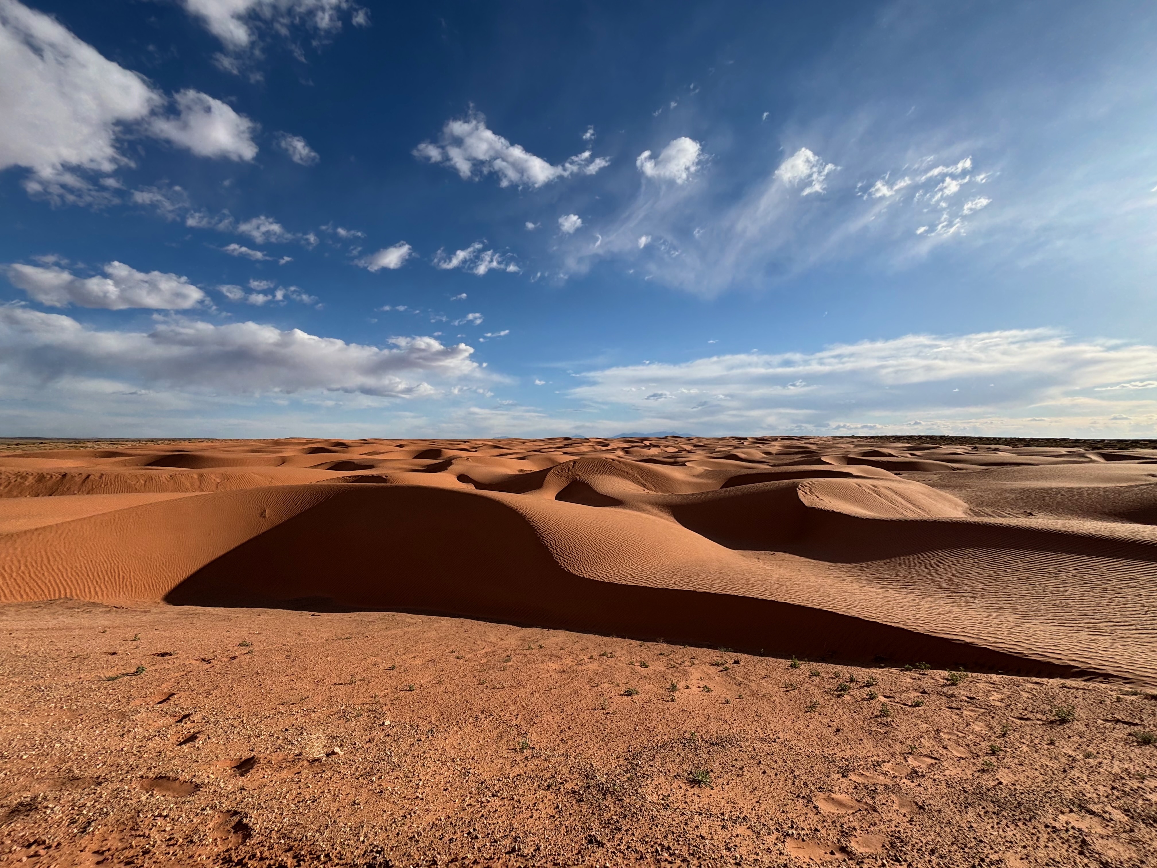Driving by sand dunes after leaving Blue John Canyon trip