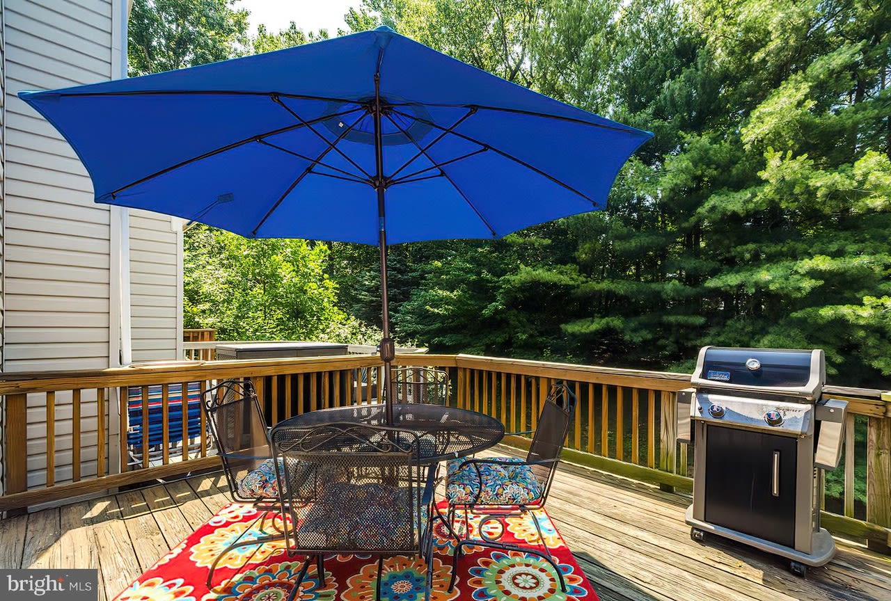 Discover your serene outdoor oasis at this charming townhouse, where a spacious deck invites you to unwind under the blue sky. Perfect for entertaining or enjoying peaceful moments, this home combines comfort with a touch of nature.