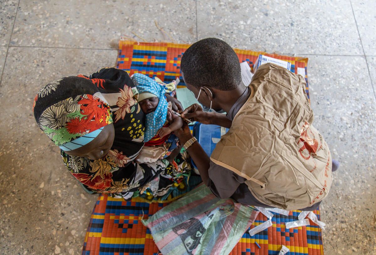 Healthworker Nura Ibrahim administers a vaccine at a school in a remote community in Jigawa State, Nigeria