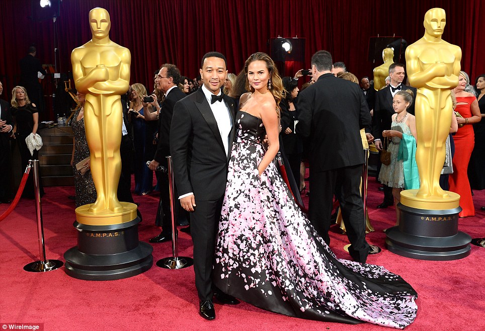 Thinking pink: Chrissy Teigen and John Legend made a dashing couple at the Dolby Theatre