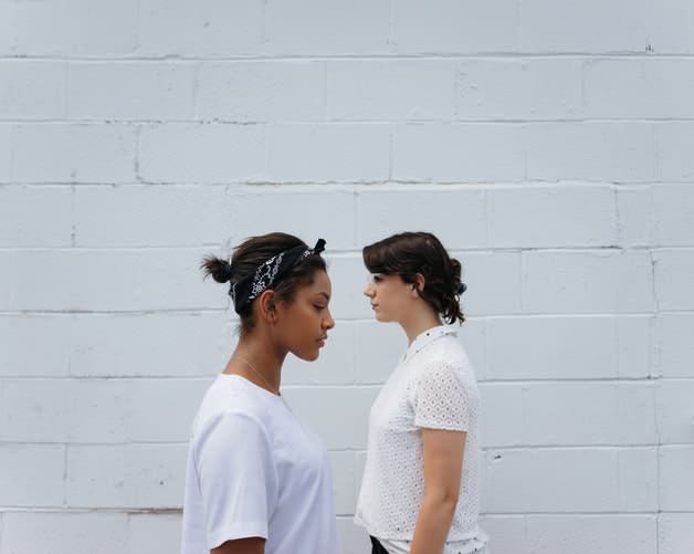 Two women walking past each other
