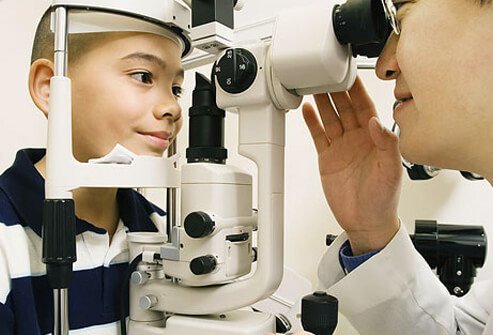 An optometrist examines a patient.
