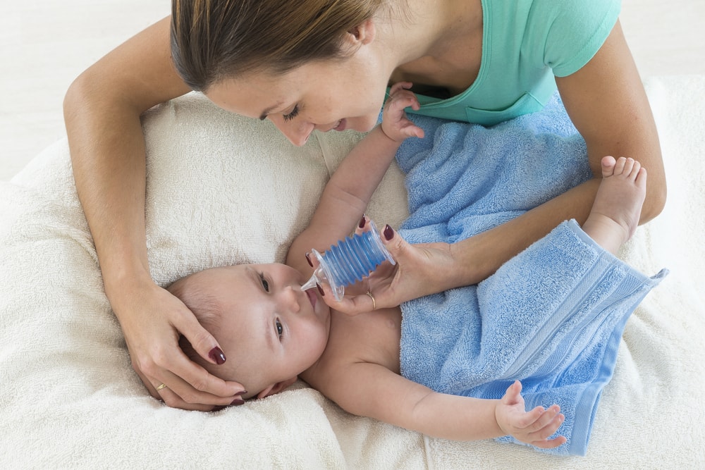 Using a rubber bulb syringe to clean baby's nose
