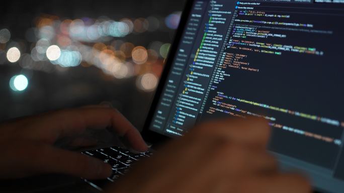 Late night programmers, code banging, computer light