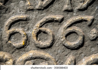 number six hundred and sixty six embossed in a metal plate. The number of the beast. Number 666 on background