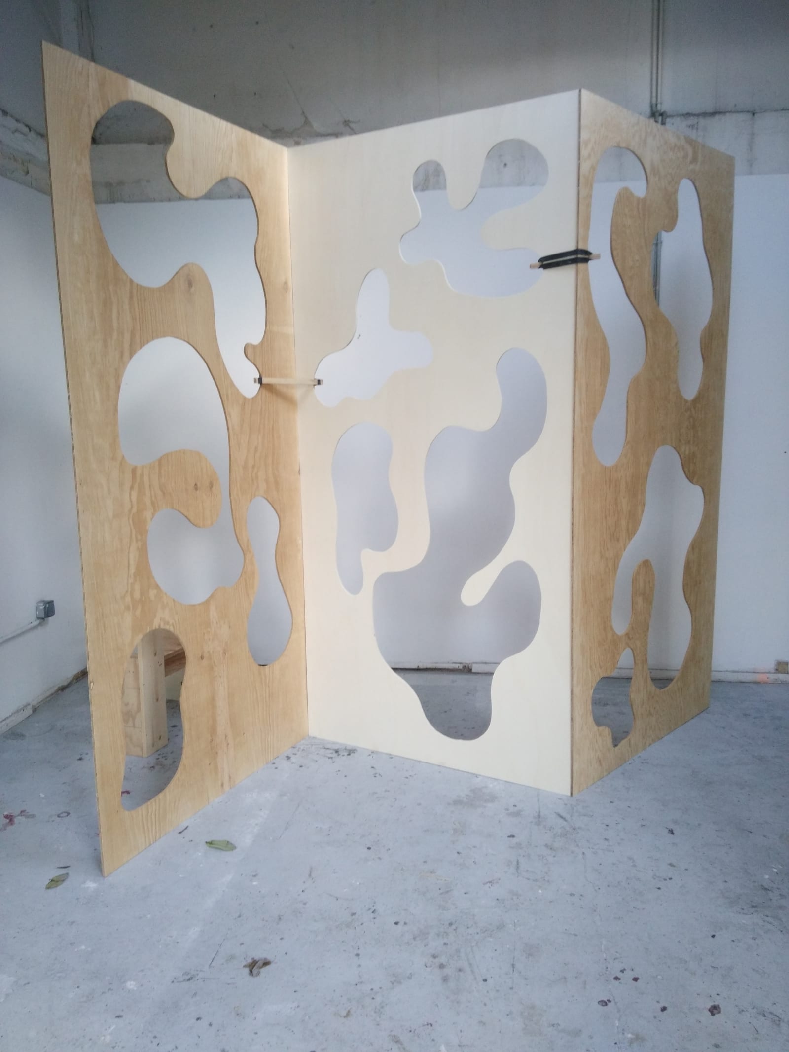see through screen - in villa belleville, three big woodboard are holding together like a screen, holes have been cut in them - wood, holes - paul lahana