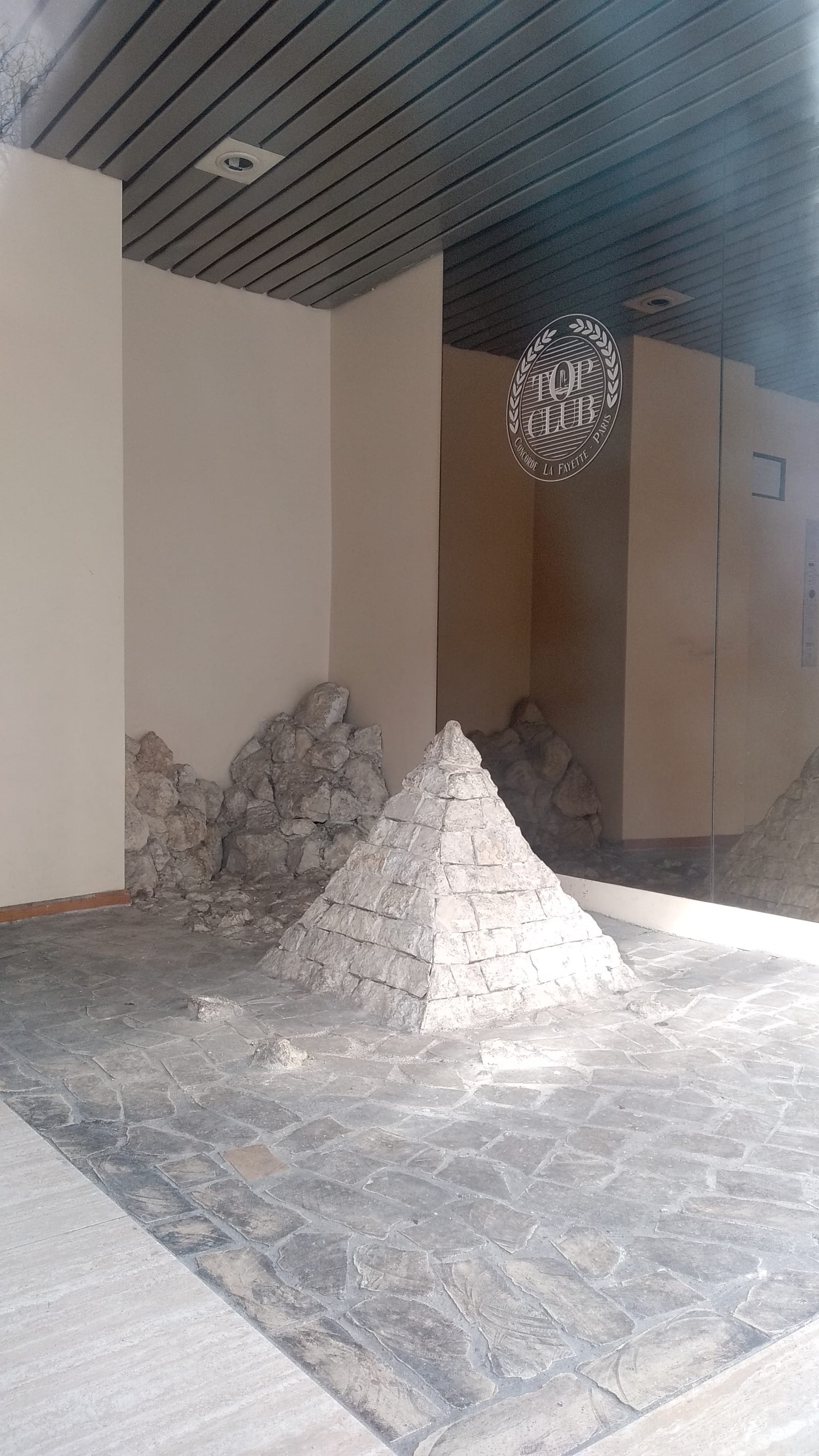 pyramids - A pyramid has been built in a building's lobby - rock, lobby - paul lahana