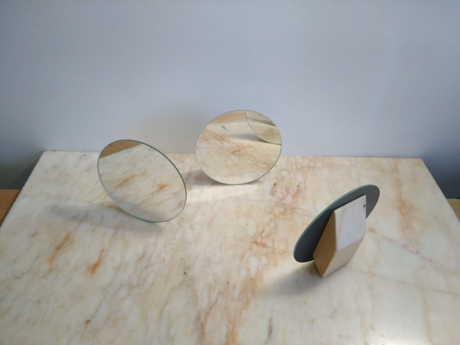 connecting - three little mirrors are standing on a marble table, waiting for a sun ray to connect them - mirrors (3), wood, marble table - paul lahana