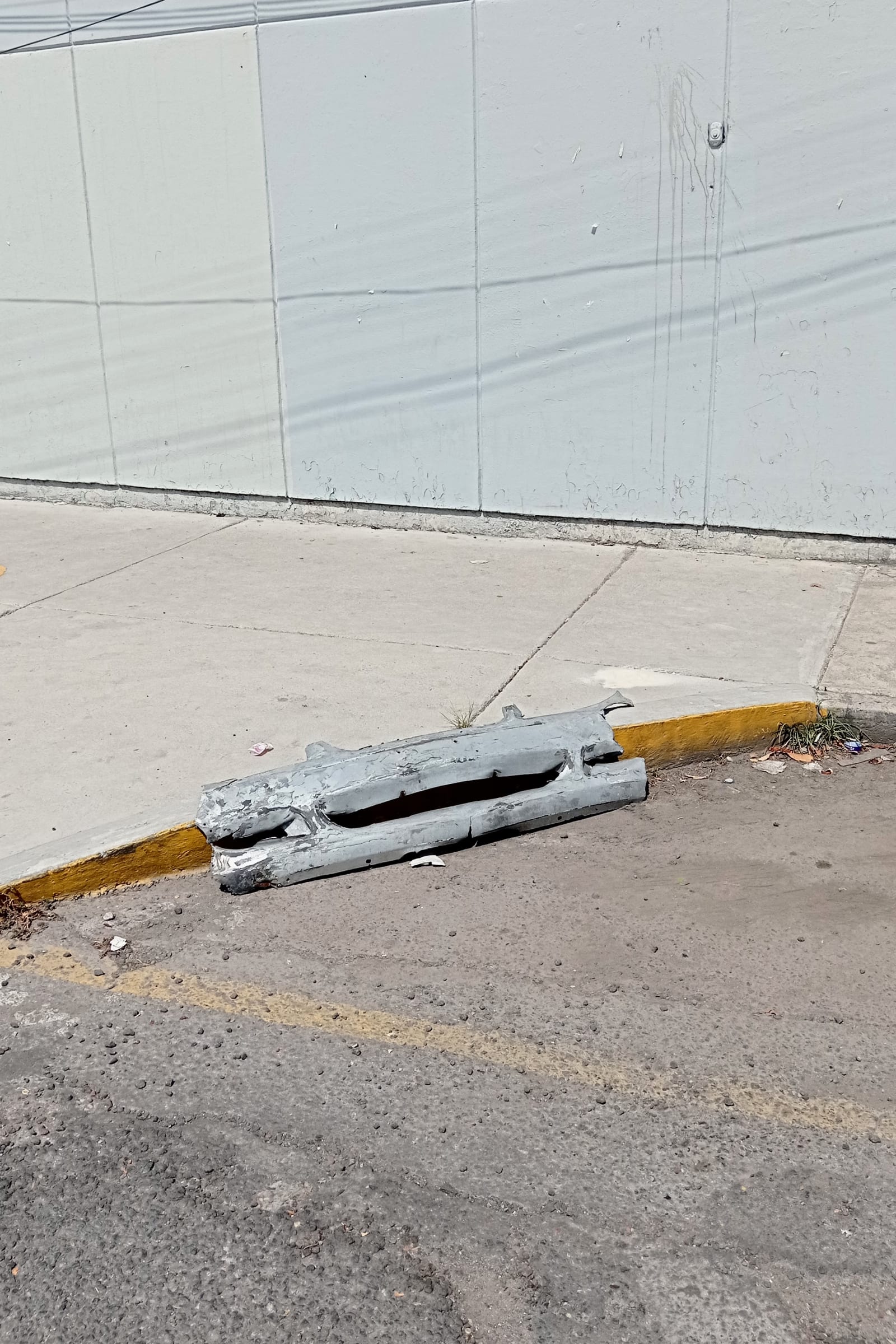 leftovers - a piece of car is left alone in the streets - piece of car, street - paul lahana