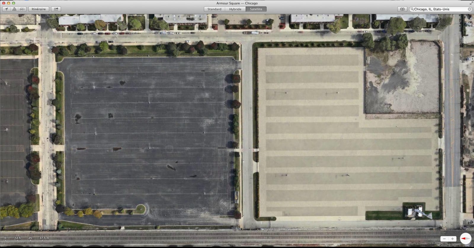armour square, chicago - a satellite view of a parking square, with one side light grey and the other dark grey - parking square - paul lahana