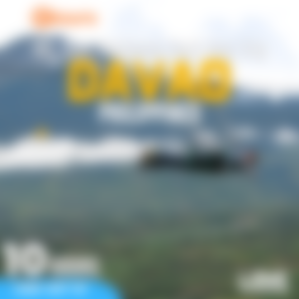 Thrill seekers ziplining through Camp Sabros' rainforest, with the beautiful Mount Apo in the background.