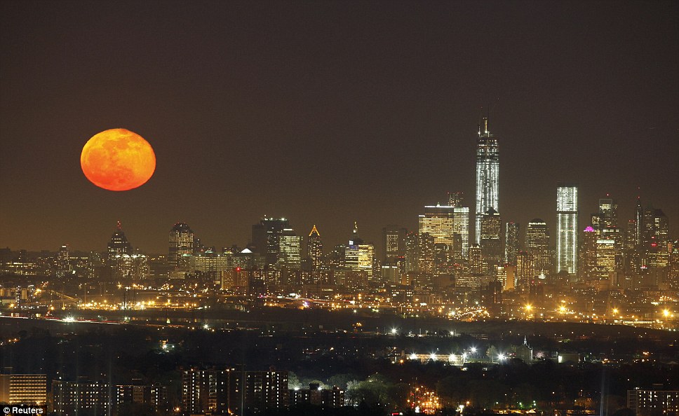 'Pink' moon: A full moon rises over the skyline of New York next to One World Trade Center in Lower Manhattan, as seen from the Eagle Rock Reservation in West Orange