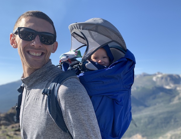 my husband using the kelty journey perfectfit child carrier with sunshade
