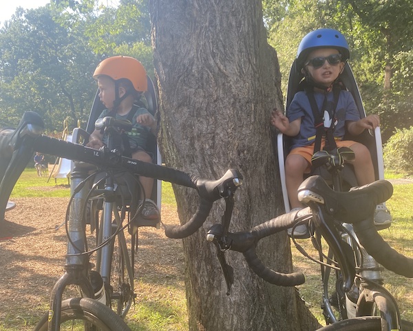 1 and 2 year old on bike seat with helmets