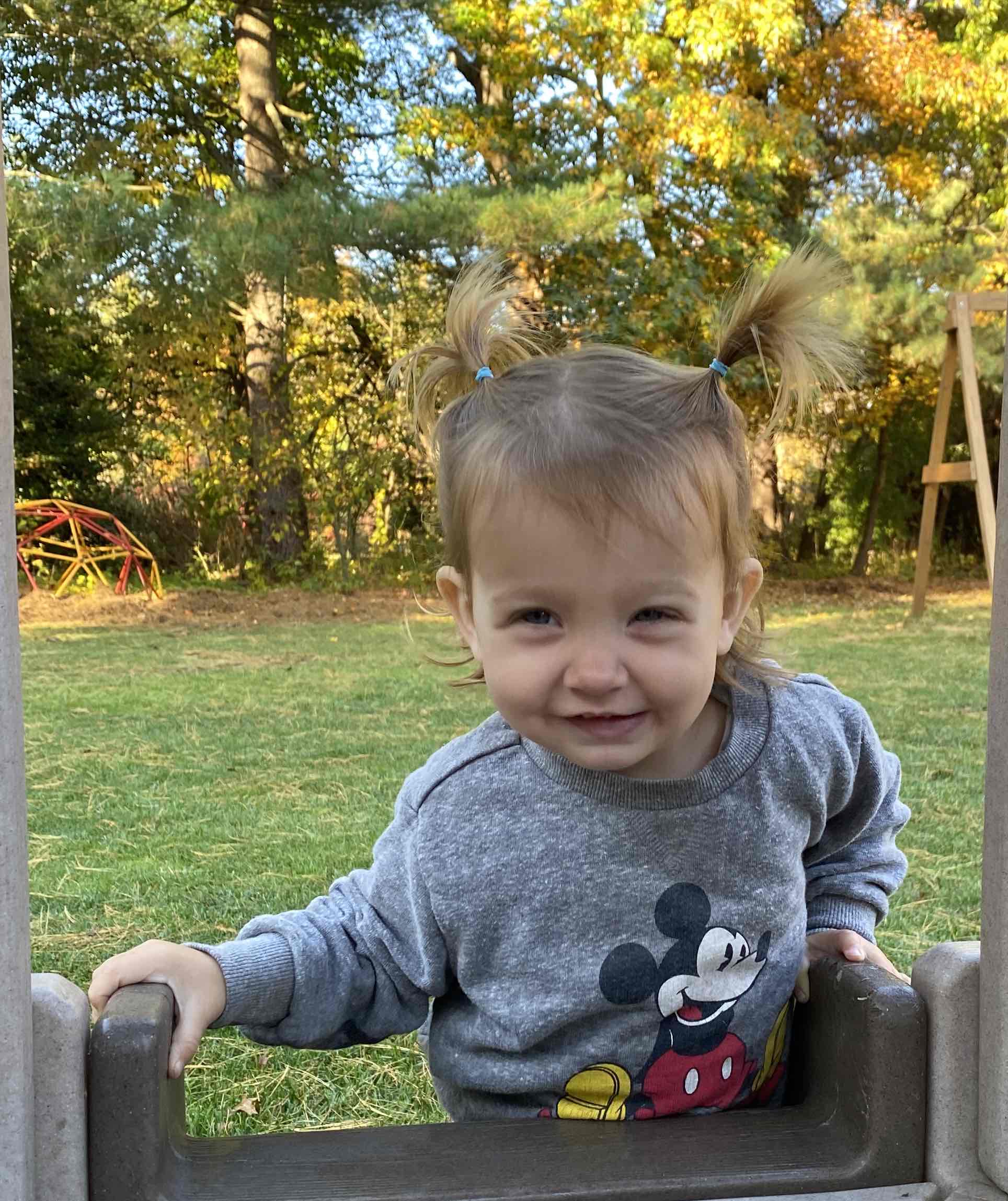 18 month old outside on mini playset