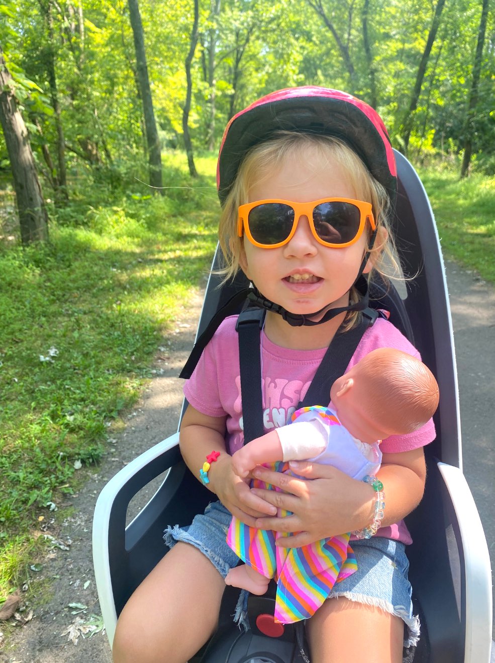 toddler riding in rear mounted bike seat on family bike ride in bucks county pa