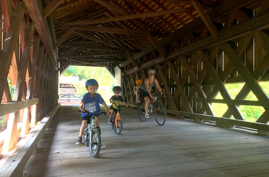 family bike riding in bucks county classic covered bridges off of D&L canal