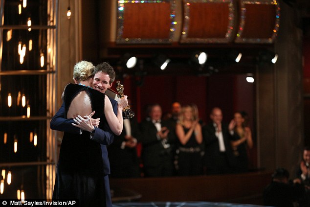 Congratulations: The mother-of-three couldn't have been happier to hand over the award to the Theory Of Everything star