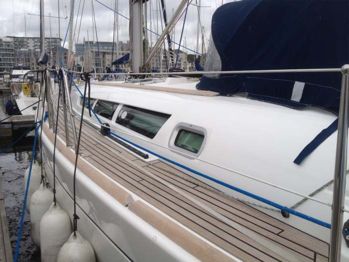 The Teak and Gelcoat Gunnels of a Yacht After a Silver Washdown