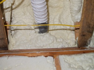 Here's the spray foam doing what it does best, sealing around stuff. This is one of the bathroom vent hoses.