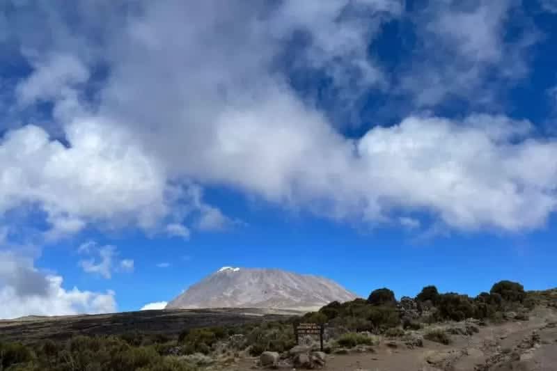 Hikers enjoying sunset from Horombo Huts during 3-day Marangu Route trek on Kilimanjaro