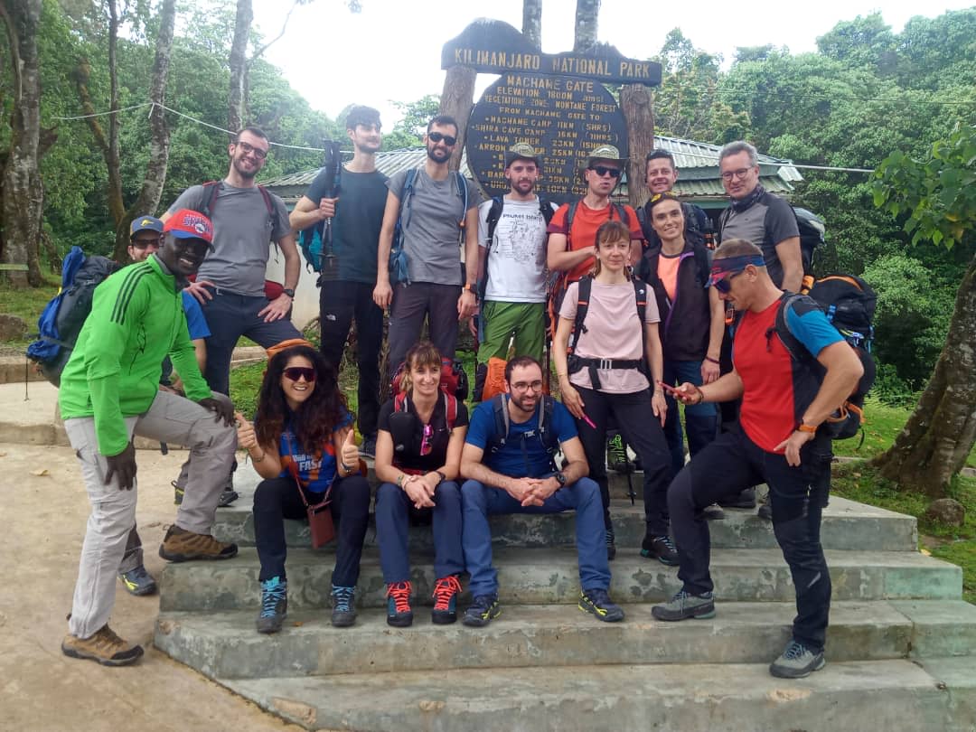 Hikers on Machame Route crossing moorlands with Kilimanjaro in the background