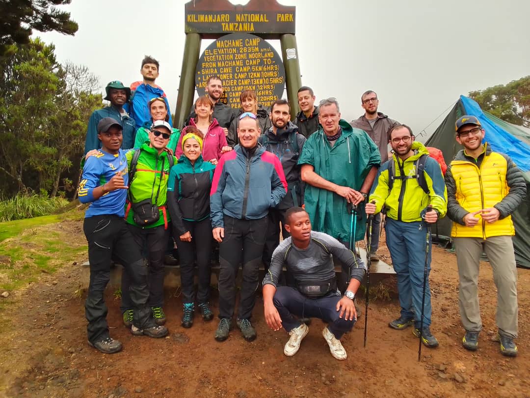 Hikers on Machame Route crossing moorlands with Kilimanjaro views