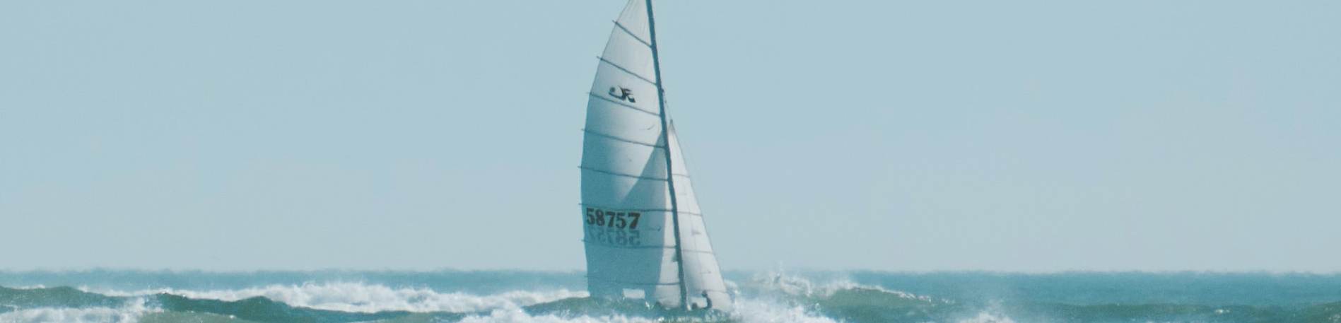 Sailboat cruises the waves at Wrightsville Beach near Del Webb's new homes in Wilmington, North Carolina.