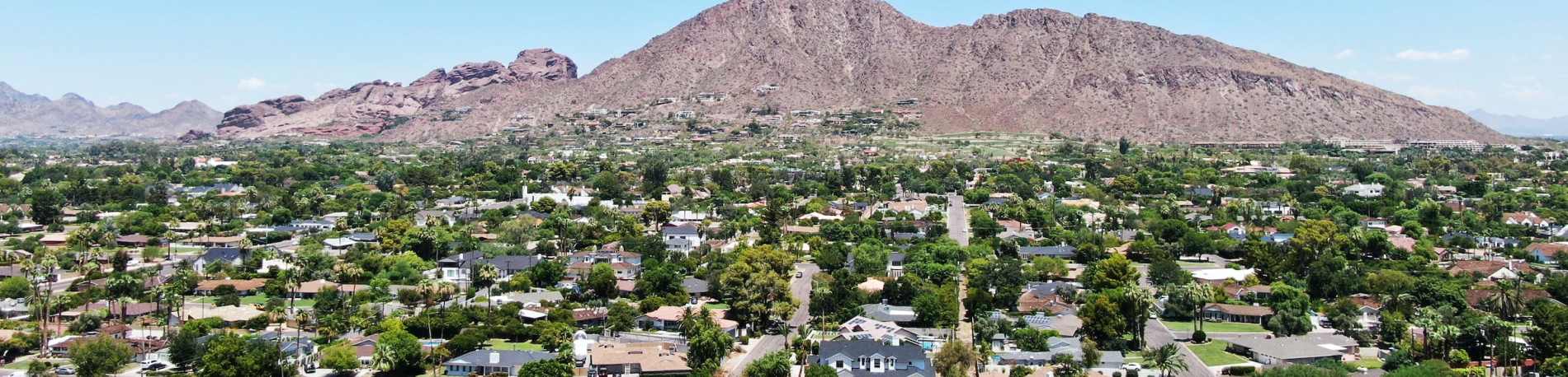 Camelback Mountain rises over the downtown Phoenix cityscape near Del Webb's new homes in Phoenix, Arizona