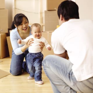 Asian Couple Moving inMove inBoxesBaby first steps