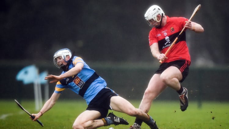 Huw Lawlor, UCD, and Michael Breen, UCC, tussle for possession at Belfield.