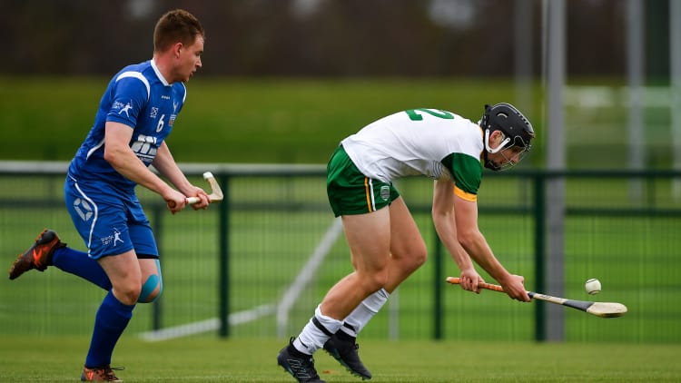 Donal Burke, Ireland, and Craig Ritchie, Scotland, in action during the Under 21 Hurling-Shinty International at the Games Development Centre in Abbotstown.