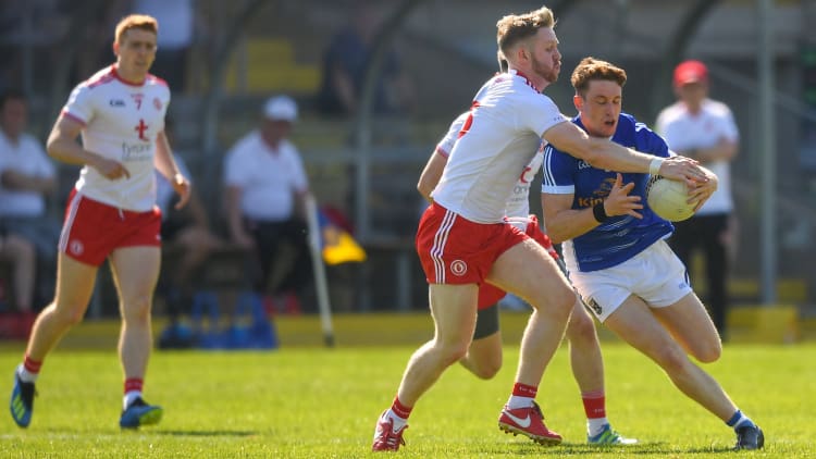 Ciaran Brady, Cavan, and Frank Burns, Tyrone, collide at Brewster Park.