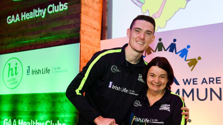 Dublin footballer Brian Fenton presenting Latton O'Rahillys Christina Weldon with her 'Hero Award' at the GAA's Healthy Clubs Conference.