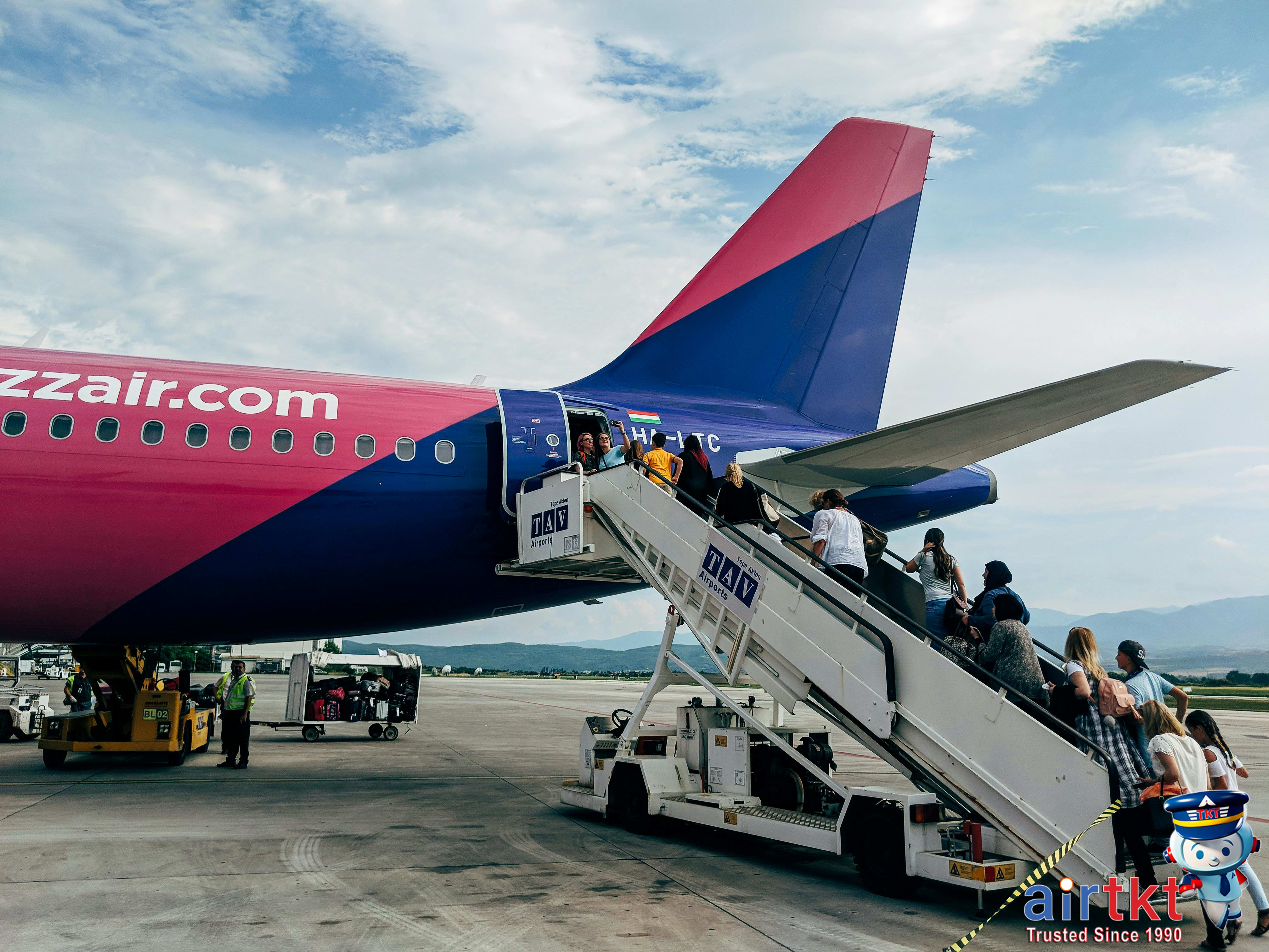 Passenger looking out airplane window during early morning flight